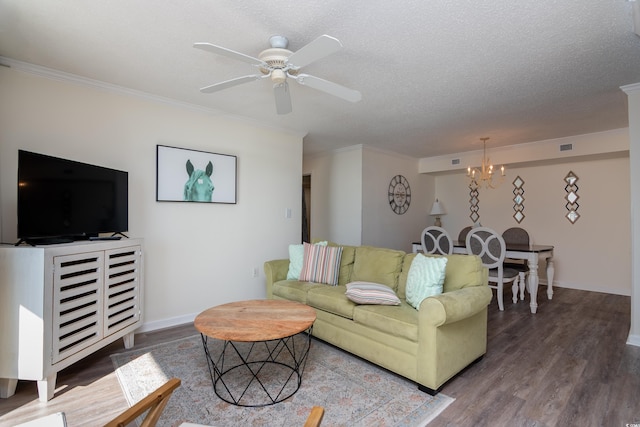 living room featuring hardwood / wood-style flooring, ceiling fan with notable chandelier, ornamental molding, and a textured ceiling