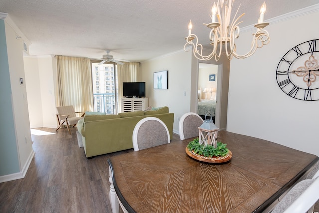 dining area featuring hardwood / wood-style flooring, ornamental molding, ceiling fan with notable chandelier, and a textured ceiling