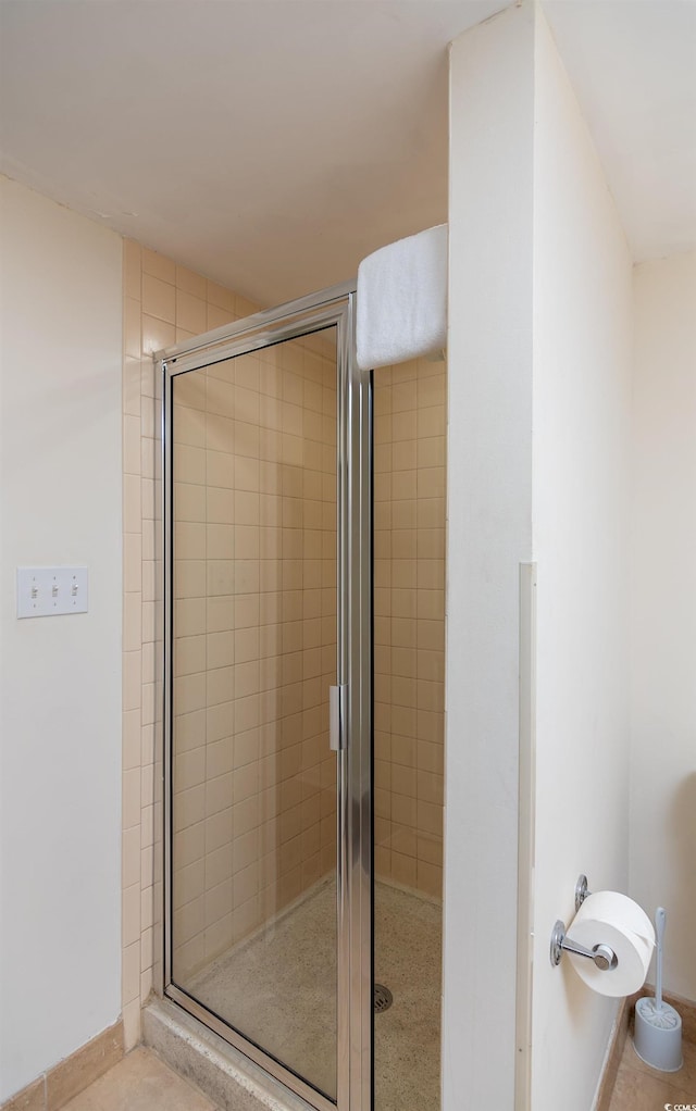 bathroom featuring walk in shower and tile patterned flooring