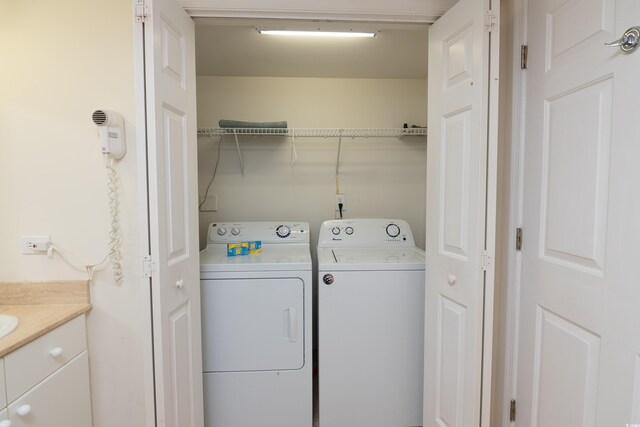 clothes washing area with washer and dryer