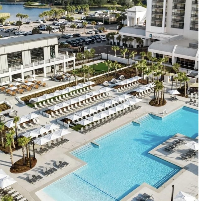 view of pool featuring a patio and a water view