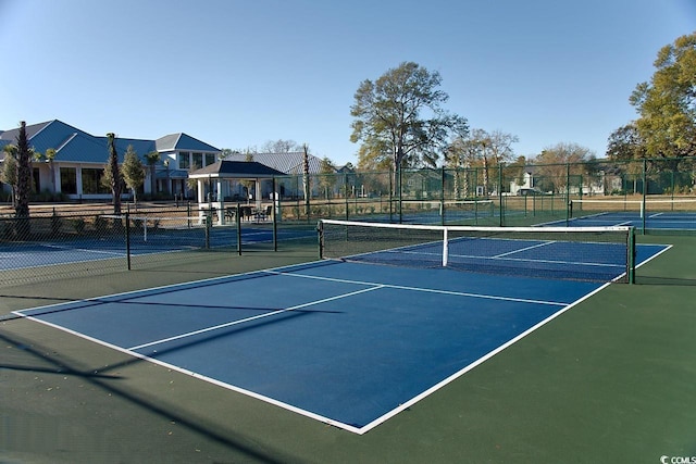 view of tennis court featuring basketball court