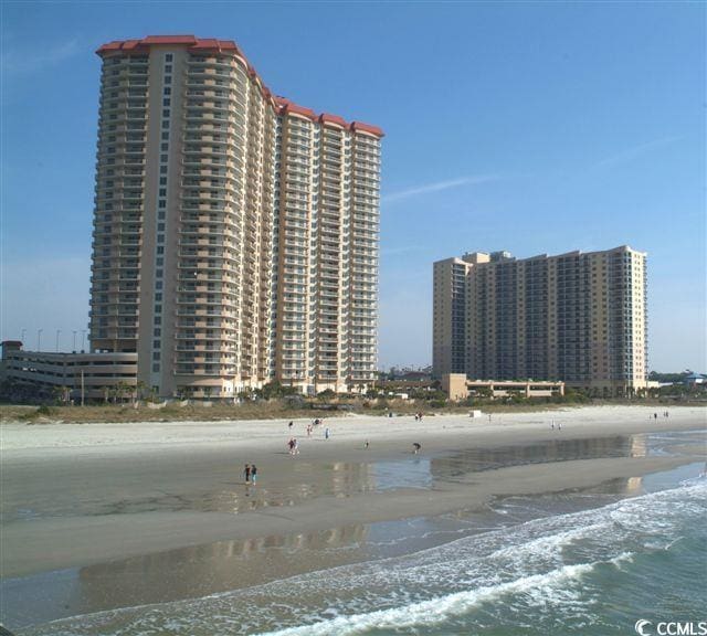 view of building exterior featuring a view of the beach and a water view