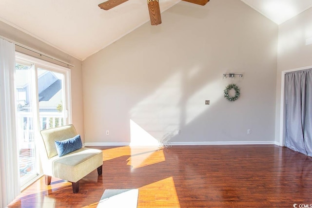 living area featuring ceiling fan, hardwood / wood-style floors, and high vaulted ceiling