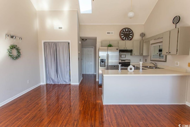 kitchen with stainless steel appliances, dark hardwood / wood-style flooring, sink, and high vaulted ceiling