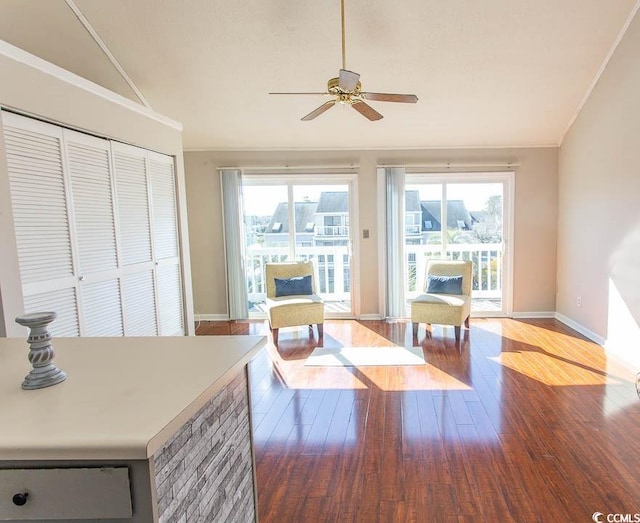 interior space featuring crown molding, vaulted ceiling, and hardwood / wood-style floors