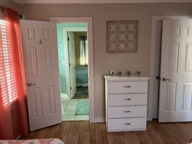 interior space with connected bathroom and hardwood / wood-style floors