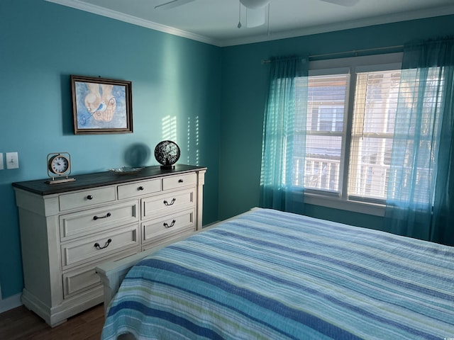 bedroom featuring ornamental molding, dark wood-type flooring, and ceiling fan