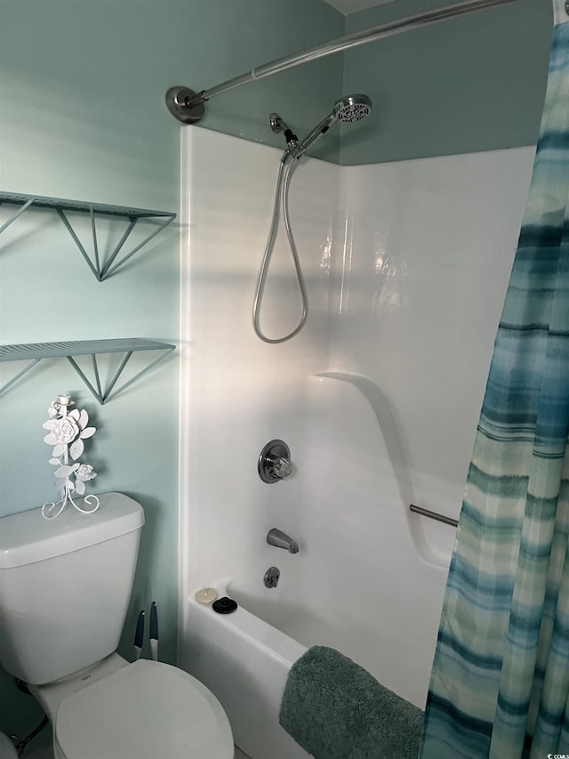 bathroom with shower / bath combination with curtain and toilet