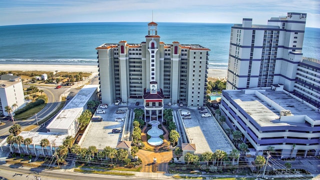 aerial view with a water view and a beach view