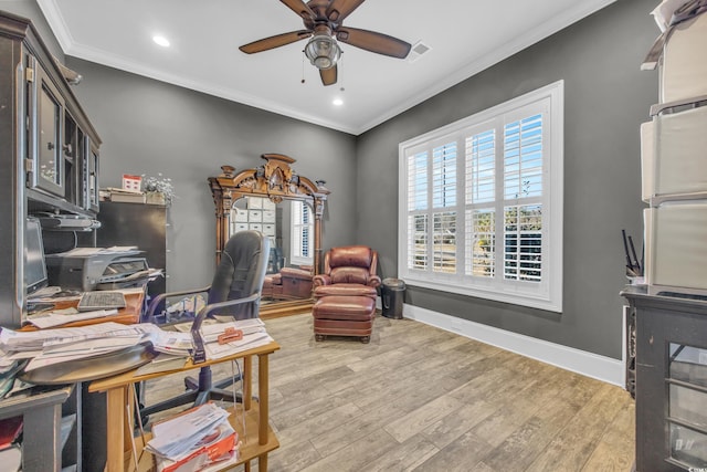 office space with crown molding, ceiling fan, and light wood-type flooring