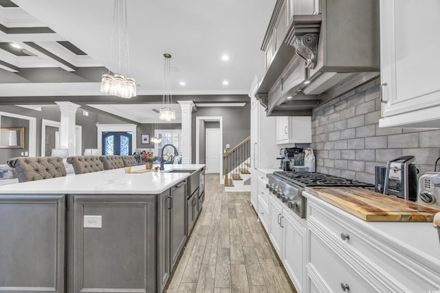 kitchen featuring white cabinetry, decorative light fixtures, and a spacious island