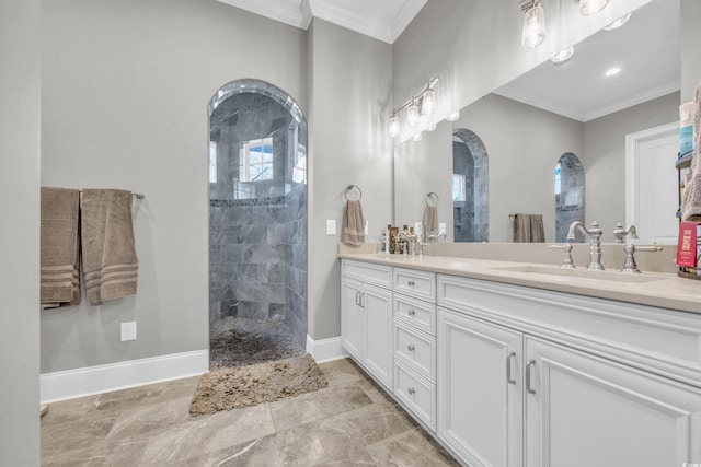 bathroom with ornamental molding, vanity, and a tile shower