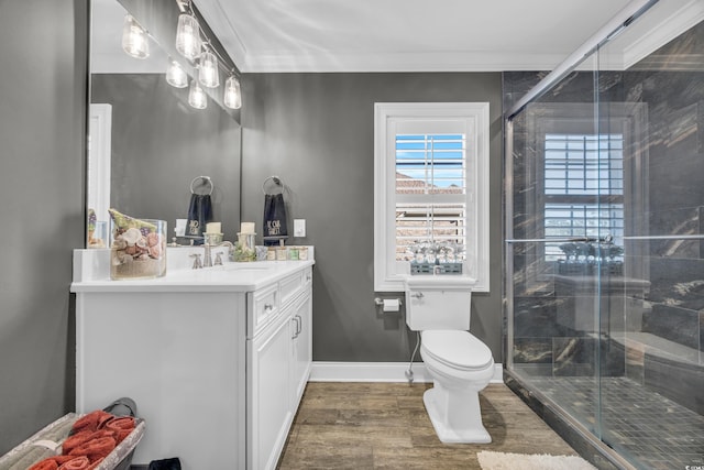 bathroom with walk in shower, toilet, crown molding, vanity, and hardwood / wood-style floors