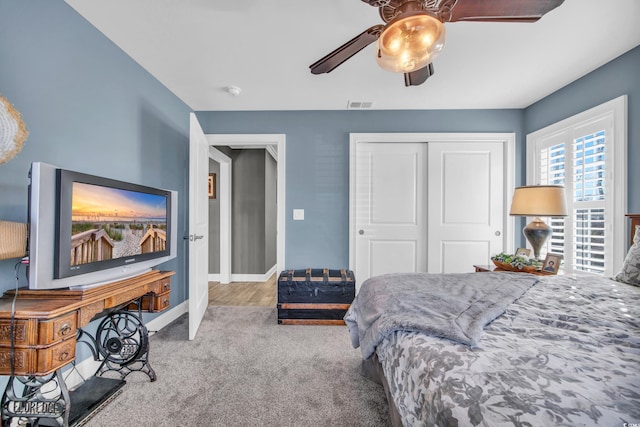 bedroom featuring light carpet, a closet, and ceiling fan