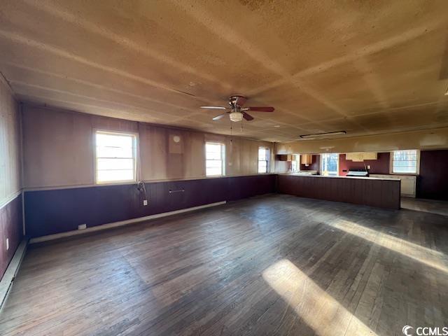 interior space featuring ceiling fan, a healthy amount of sunlight, and hardwood / wood-style flooring