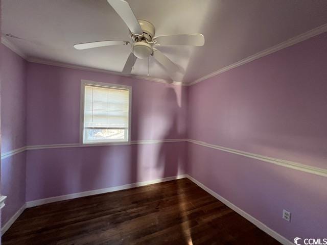 empty room featuring ceiling fan, dark hardwood / wood-style flooring, and crown molding