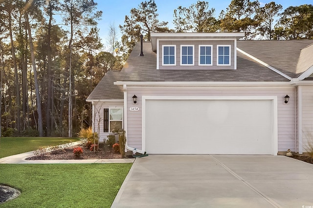 view of front of house with a garage and a front yard