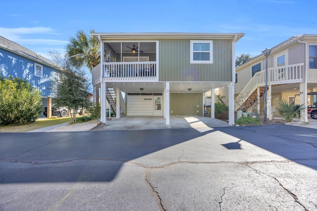 raised beach house with ceiling fan and a carport