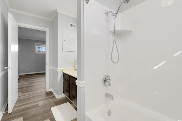 bathroom featuring hardwood / wood-style floors, shower / tub combination, vanity, and crown molding