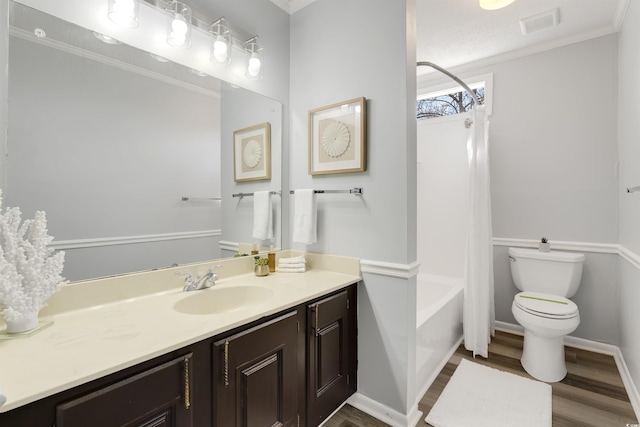 full bathroom featuring vanity, shower / bath combination, toilet, hardwood / wood-style flooring, and crown molding