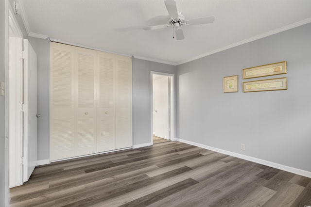 unfurnished bedroom with ceiling fan, dark hardwood / wood-style flooring, a closet, and ornamental molding