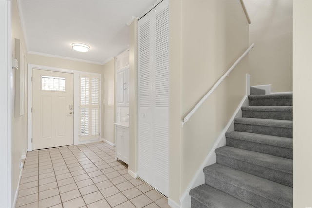 entrance foyer featuring light tile patterned floors and ornamental molding