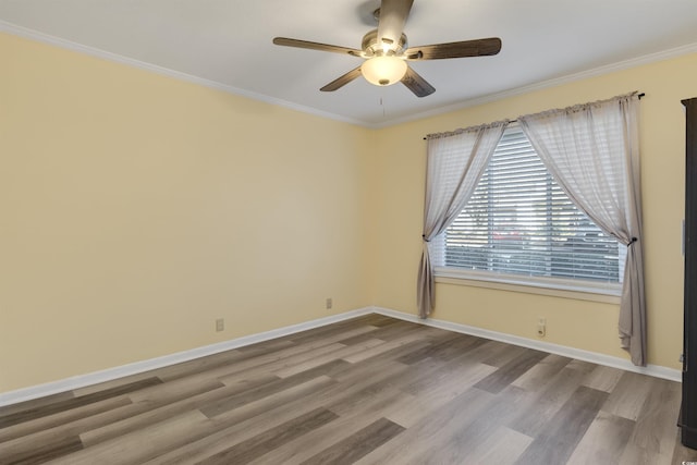 empty room with ceiling fan, crown molding, and light wood-type flooring