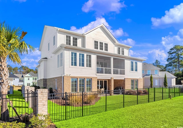 view of front of home with a front lawn and a sunroom