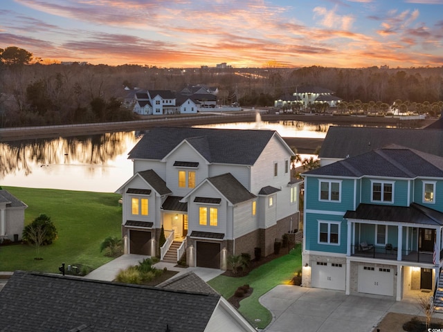 view of front of home featuring a water view and a garage