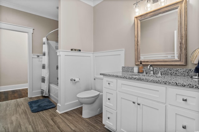 full bathroom with wood-type flooring, vanity, shower / tub combo, toilet, and crown molding