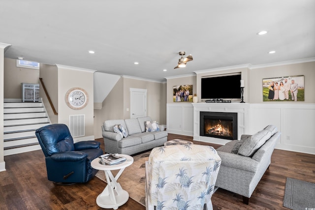 living room with dark hardwood / wood-style floors and crown molding