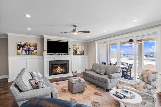 living room featuring hardwood / wood-style flooring, crown molding, and ceiling fan