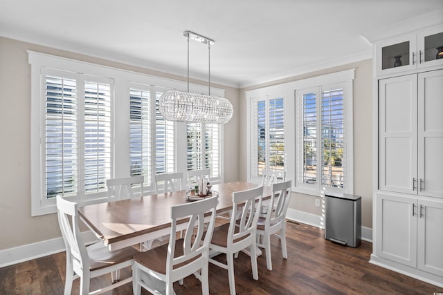 dining space with dark hardwood / wood-style floors, crown molding, and a chandelier