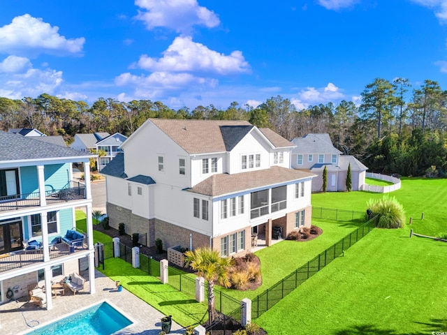 rear view of property with a patio area, outdoor lounge area, a yard, and a balcony