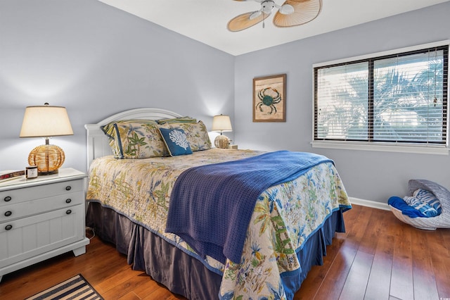 bedroom with ceiling fan and dark hardwood / wood-style flooring