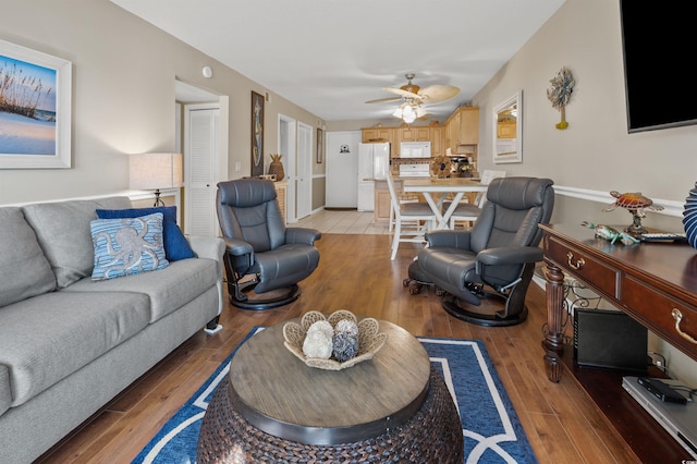 living room with hardwood / wood-style flooring and ceiling fan