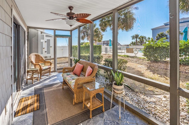 sunroom featuring ceiling fan