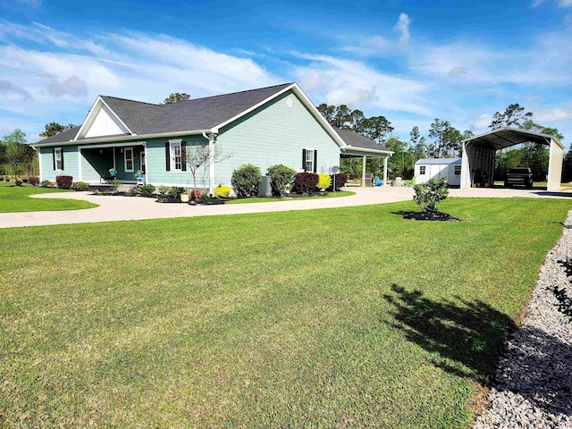 view of side of property with a detached carport, concrete driveway, and a yard