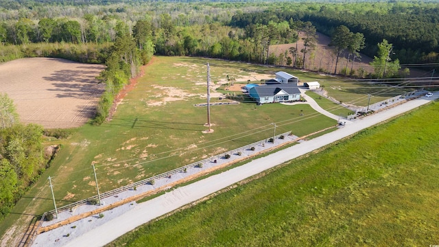 bird's eye view with a wooded view and a rural view