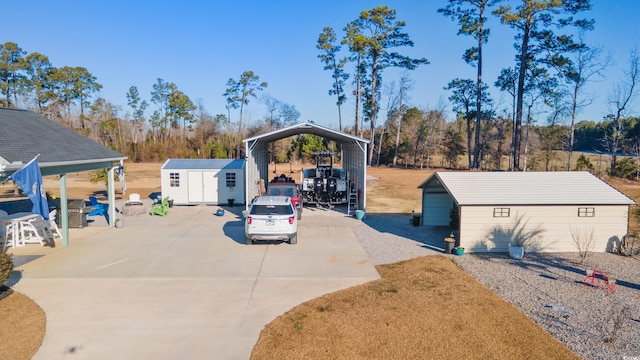 view of front of house with a detached carport, an outdoor structure, driveway, and a storage shed