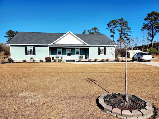 ranch-style home featuring a porch and a front lawn