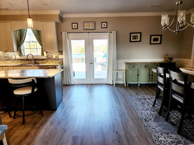 interior space with a notable chandelier, crown molding, french doors, visible vents, and dark wood-type flooring