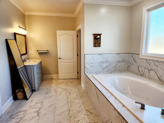 full bathroom featuring ornamental molding, a jetted tub, vanity, and baseboards