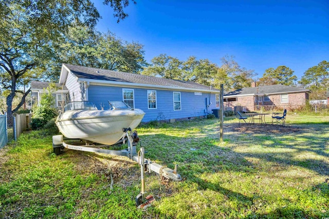 back of property featuring a lawn