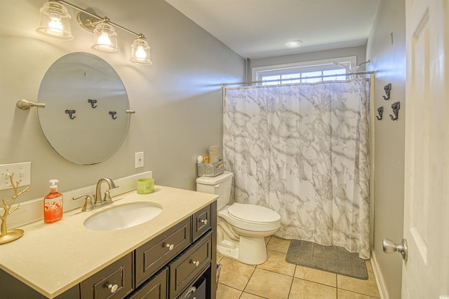 bathroom with toilet, tile patterned flooring, walk in shower, and vanity