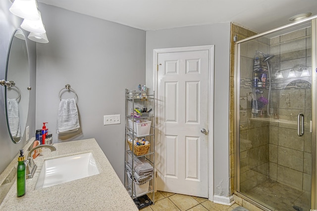 bathroom with walk in shower, vanity, and tile patterned flooring