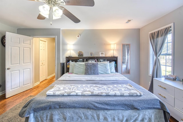 bedroom with ceiling fan and wood-type flooring