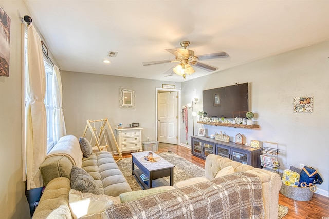 living room featuring ceiling fan and wood-type flooring