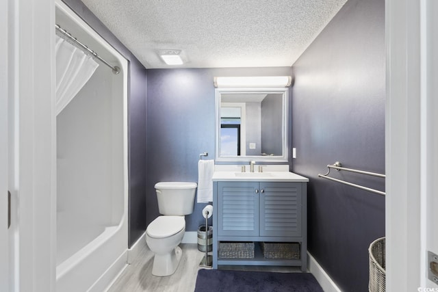 full bathroom with a textured ceiling, vanity, toilet, hardwood / wood-style flooring, and shower / bath combo